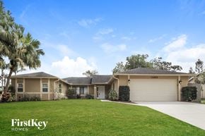 Palm Bay house for rent - A house with a garage and a driveway in front of it.