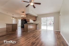 Palm Bay house for rent - A spacious kitchen and living room with wooden floors and a ceiling fan.