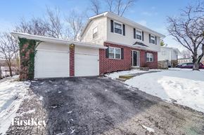 Columbus house for rent - A house with a white garage door and a brick chimney.