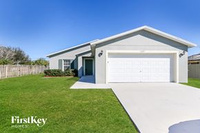 Port St. Lucie house for rent - A house with a garage and a driveway in front of it.