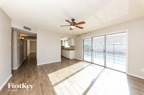 Glendale house for rent - A spacious room with a ceiling fan and sliding glass doors.