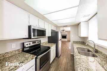 Glendale house for rent - A kitchen with granite countertops and white cabinets.