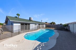Glendale house for rent - A swimming pool in a backyard with a FirstKey Homes logo.