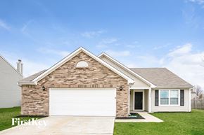 Fishers house for rent - A brick house with a garage door and a window.