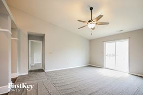 Fishers house for rent - A spacious room with a ceiling fan and carpeted floor.