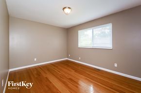 Florissant house for rent - the second bedroom with hardwood flooring and a large window