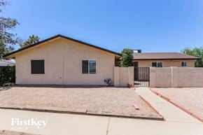 Glendale house for rent - A house with a brown roof and a fence in front of it.
