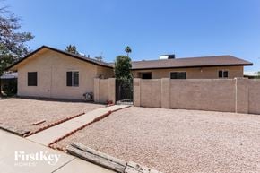 Glendale house for rent - A house with a brown roof and a brown fence is shown.