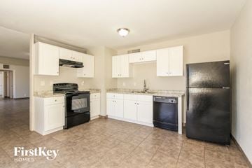 Glendale house for rent - A kitchen with black appliances and white cabinets.