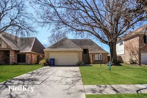 Houston house for rent - a house with a driveway and a garage door
