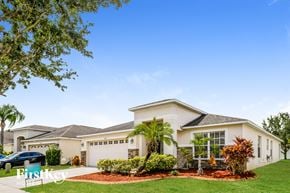 Riverview house for rent - a house with palm trees in front of it