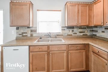 Riverview house for rent - a kitchen with wooden cabinets and a sink