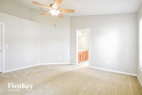 Riverview house for rent - a living room with white walls and a ceiling fan