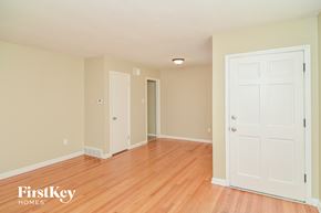 Memphis house for rent - a bedroom with wood floors and a white door