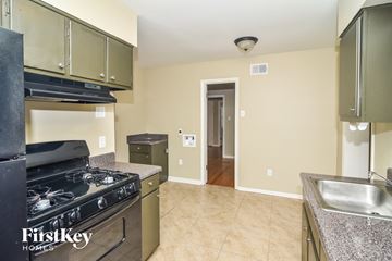 Memphis house for rent - a kitchen with granite counter tops and stainless steel appliances and a stove top oven