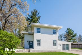 Winthrop Harbor house for rent - a white house with a green lawn and trees