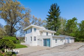 Winthrop Harbor house for rent - a white house with a driveway and a blue garage door