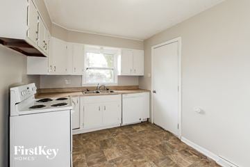 Gladstone house for rent - A kitchen with a stove top oven and a dishwasher.
