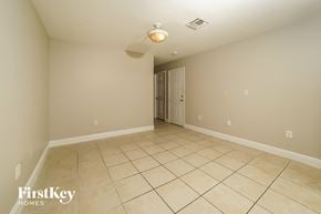 Homestead house for rent - A spacious empty room with a doorway leading to another room.