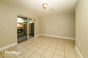 Homestead house for rent - A room with a tiled floor and a sliding glass door leading outside.