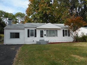 Florissant house for rent - A white house with a grey roof and a small porch.