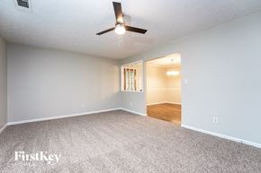 Conyers house for rent - A spacious room with a carpeted floor and a ceiling fan.