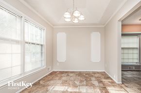 Blue Springs house for rent - A room with a tiled floor and a chandelier hanging from the ceiling.