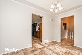 Blue Springs house for rent - A room with a tiled floor and a chandelier.