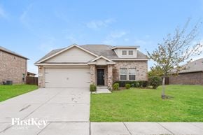 Royse City house for rent - a white and brick house with a yard and a driveway