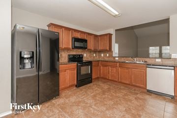 Royse City house for rent - a kitchen with stainless steel appliances and wooden cabinets