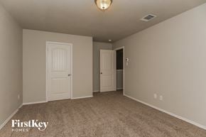 Royse City house for rent - a bedroom with a carpeted floor and a white door