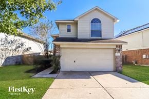Houston house for rent - a white house with a white garage door and a lawn