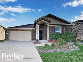 Royse City house for rent - A house with a garage and a brick wall.