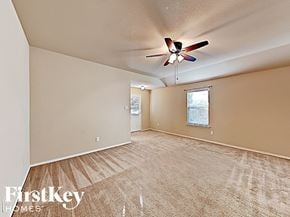 Royse City house for rent - A room with a fan and a window with blinds.