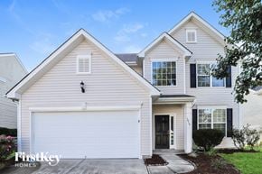 Mcleansville house for rent - A two-story house with a garage and a driveway.