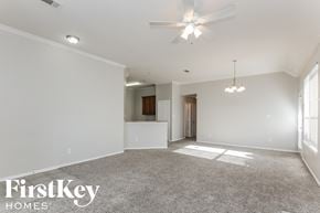 Dallas house for rent - an empty living room with a ceiling fan and a kitchen