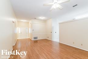 Fleming Island house for rent - A spacious room with wooden floors and a ceiling fan.