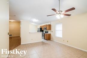 Fleming Island house for rent - A spacious room with a fan and a kitchenette.