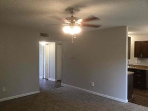 Garland house for rent - an empty living room with a ceiling fan
