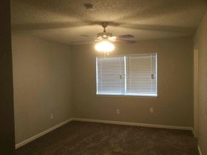 Garland house for rent - a bedroom with a ceiling fan and a window