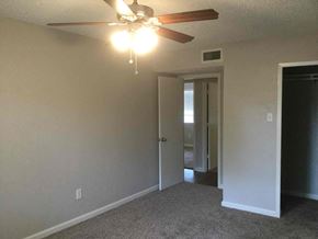 Garland house for rent - a living room with a ceiling fan and a door to a hallway