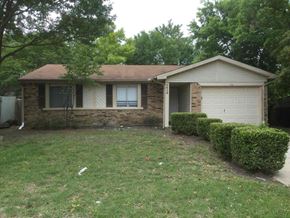 Garland house for rent - a small brick house with a lawn and bushes