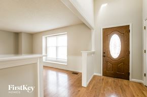 Olathe house for rent - an empty room with a wooden door and a window