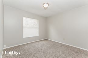 Poinciana house for rent - a bedroom with a large window and a carpet