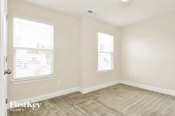 Mcleansville house for rent - a living room with a carpet and two windows