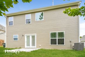 Mcleansville house for rent - the outside of a house with tan siding and green grass