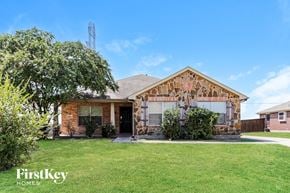 Lancaster house for rent - a small brick house with a garage and a lawn