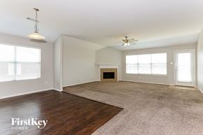 Lancaster house for rent - an empty living room with a fireplace and wood flooring