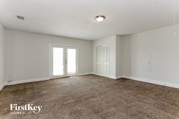 Lancaster house for rent - a spacious living room with carpet and white walls