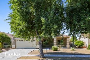 Surprise house for rent - a tree in front of a house with a garage door